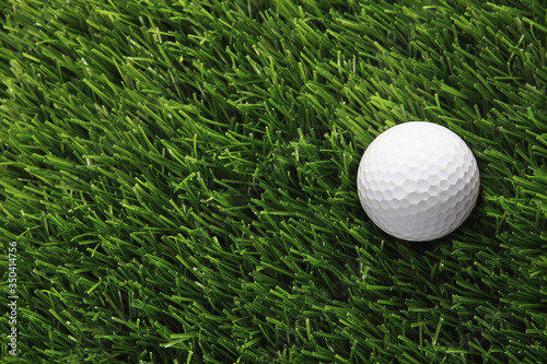 Golf ball placed on grass