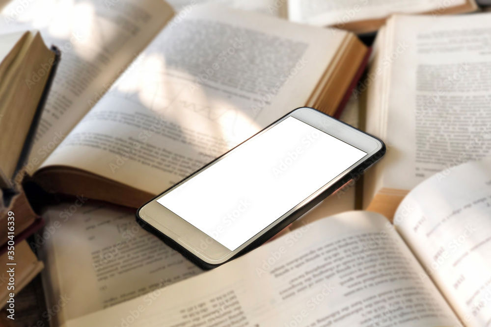 Fototapeta premium Books and smartphone in library
