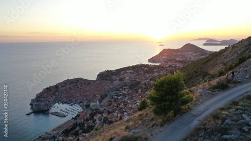 Slika na platnu Aerial view of Dubrovnik old town at foot of mountain, Adriatic sea at sunset