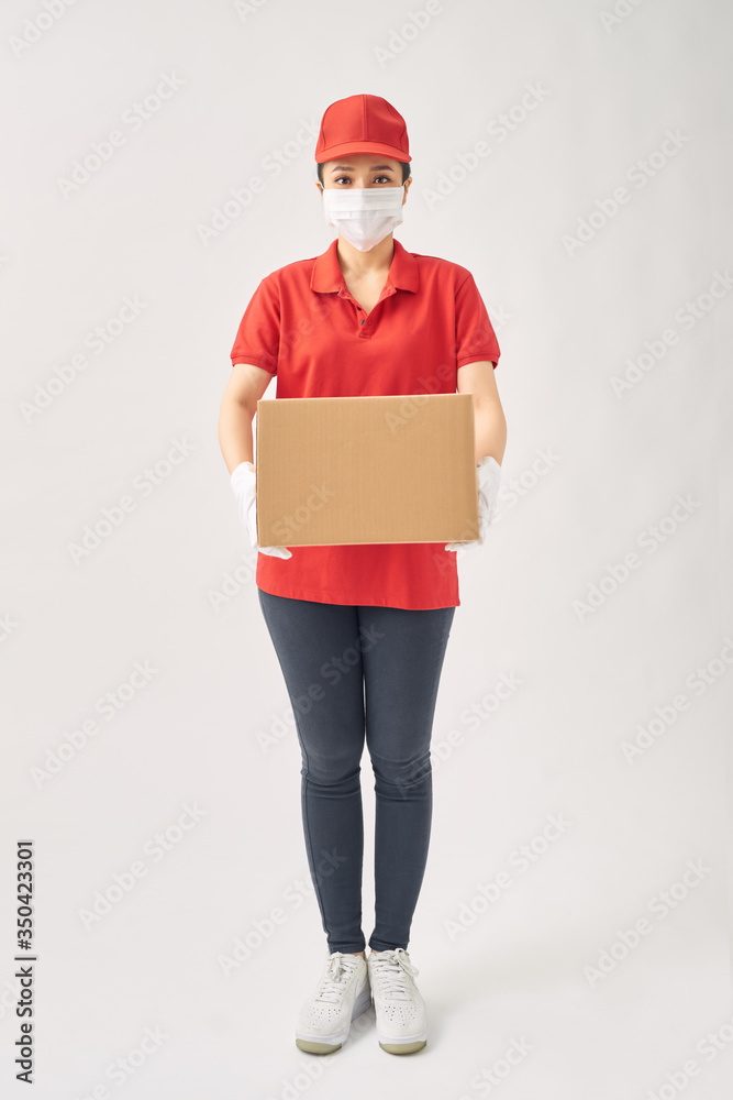 Delivery women in medical mask and rubber gloves holding cardboard boxes. Delivery women in medical mask and rubber gloves holding cardboard boxes.