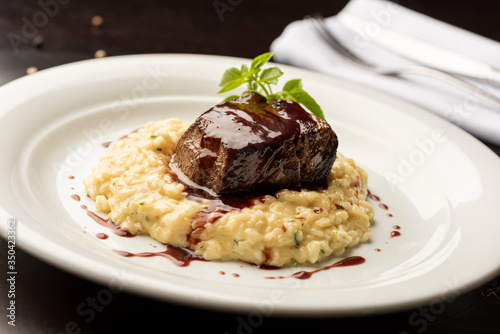 steak sirloin tenderloin with wine sauce and risotto on plate