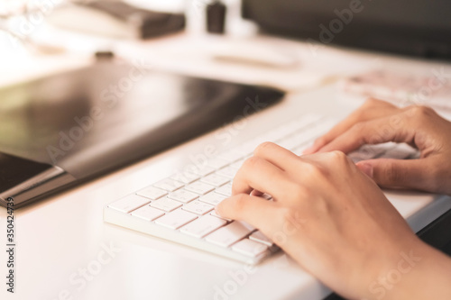 Woman hand using laptop to work study on work desk with clean nature background background. Business, financial, trade stock maket and social network.