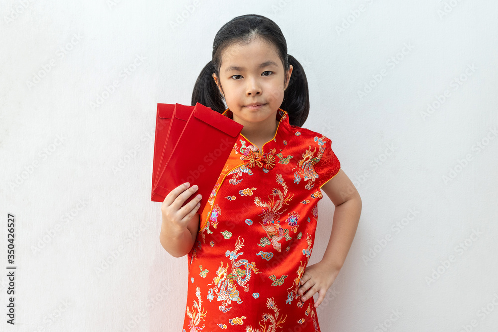 Asian girl wear cheongsam and take Red envelopes in chinese new year Asian girl wear cheongsam and take Red envelopes in chinese new year
