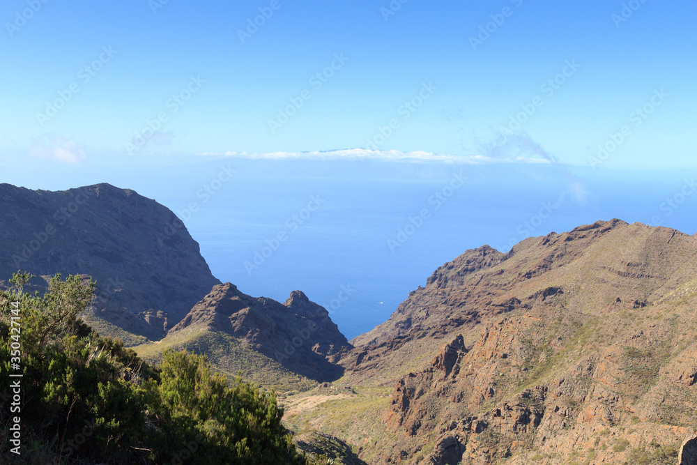 Cliffs and rocks panorama with Atlantic Ocean and La Gomera in the background on Canary Island Tenerife, Spain