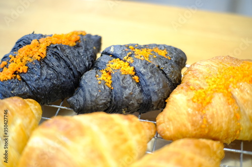 Fresh tasty croissants as background, closeup. French pastry  photo