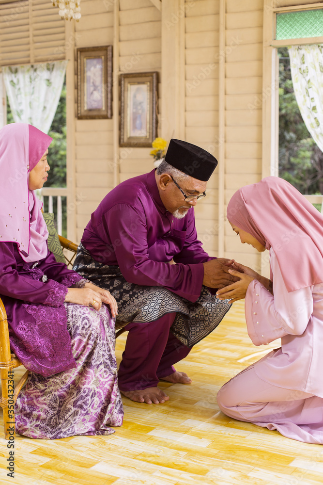 Traditional act of respect in Muslim family on Eid al-Fitr
