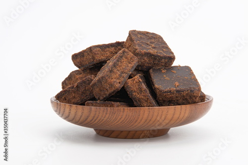 A plate of brown sugar on a white background