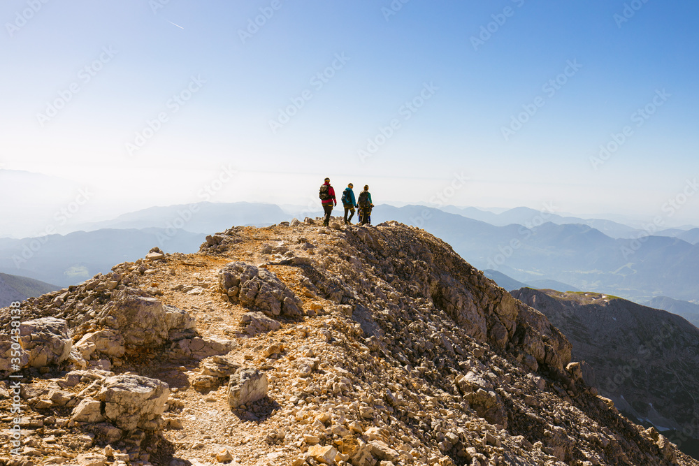 Three Hikers in climbing equipment near summit of mountain (Mt. Triglav, Slovenia)