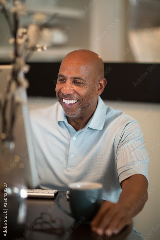 Mature African American man working from his home office. Mature African American man working from his home office.