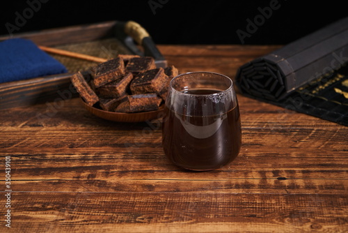 A glass of brown sugar water is on the retro table top