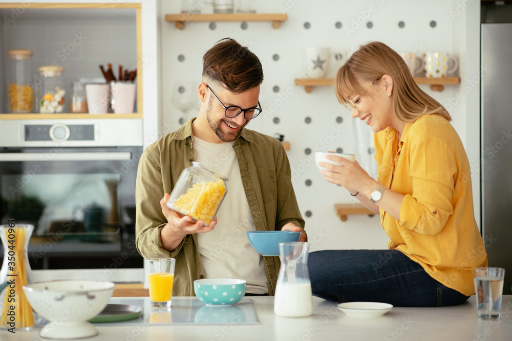 Young couple making breakfast at home. Loving couple enjoying in morning.. Young couple making breakfast at home. Loving couple enjoying in morning..