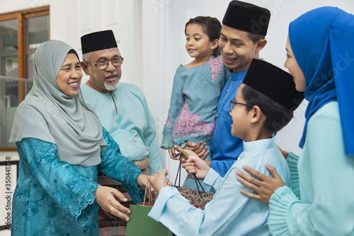 Muslim family visiting senior couple on Eid al-Fitr