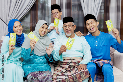 Muslim family with green envelopes