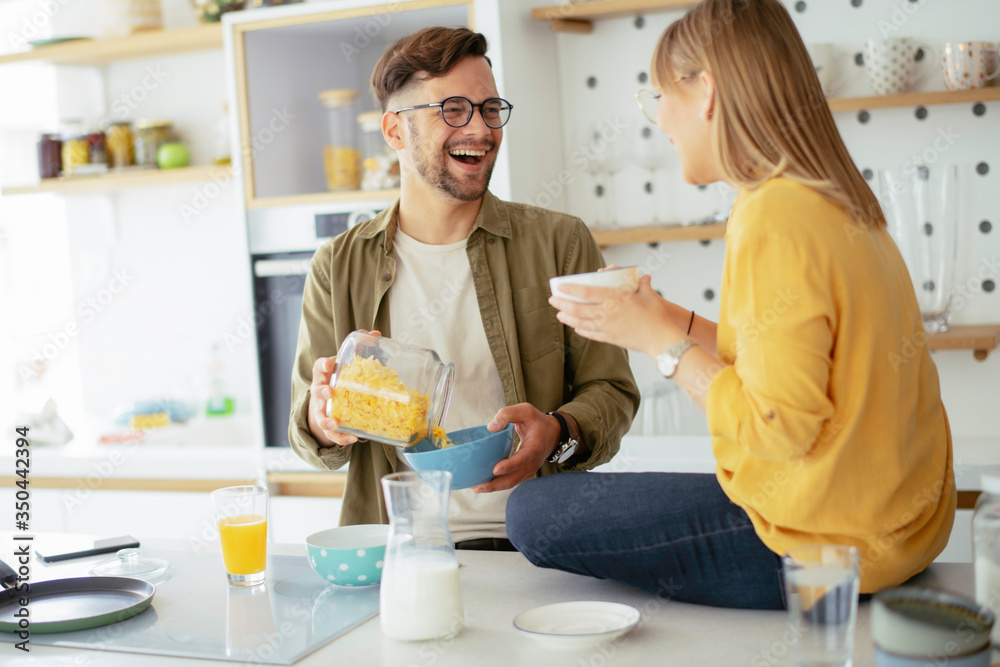 Young couple making breakfast at home. Loving couple enjoying in morning.. Young couple making breakfast at home. Loving couple enjoying in morning..