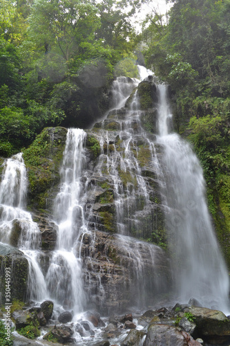 Water fall in the green area of the forest in the Himalayan mountains