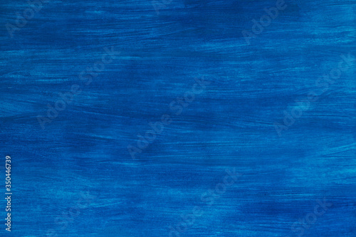 Hand painted gouache on paper in a bright blue background. Beautiful abstract light blue background texture. Copy space, background, sky color, sea color, needlework background.