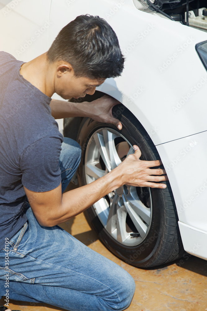 Man checking car tire Man checking car tire