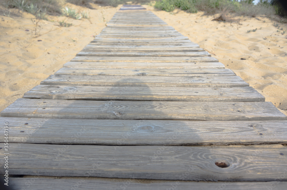boardwalk leading to the beach on the sand boardwalk leading to the beach on the sand