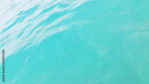 Turquoise background. The surface of the sea water.
