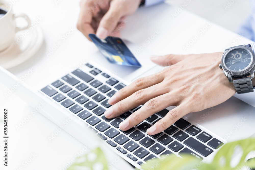 Man holding a credit card for online shopping Man holding a credit card for online shopping