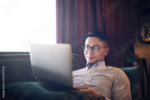 Man using a laptop on a couch