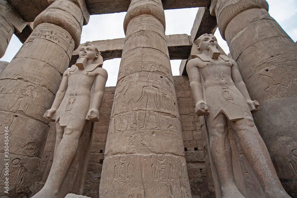 Hieroglyphic carvings on ancient egyptian temple columns and statues ...