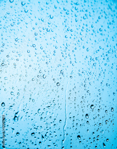 Raindrops on glass against the sky