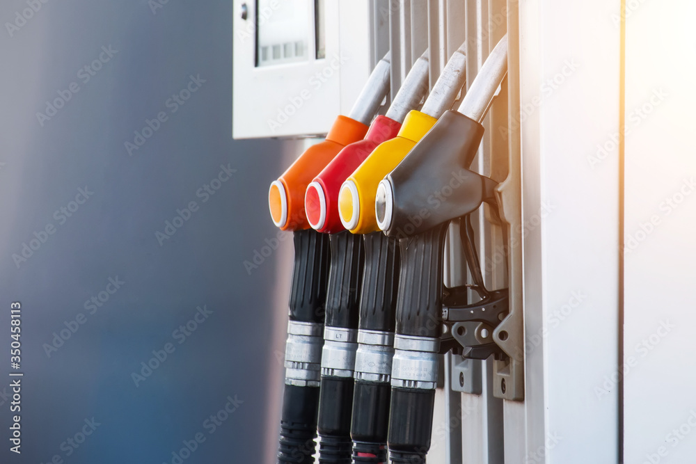 Service gas station with fuel, oil, gasoline and diesel, side view. Close-up of a gas pump fueling gun. Petrol station. Service gas station with fuel, oil, gasoline and diesel, side view. Close-up of a gas pump fueling gun. Petrol station.