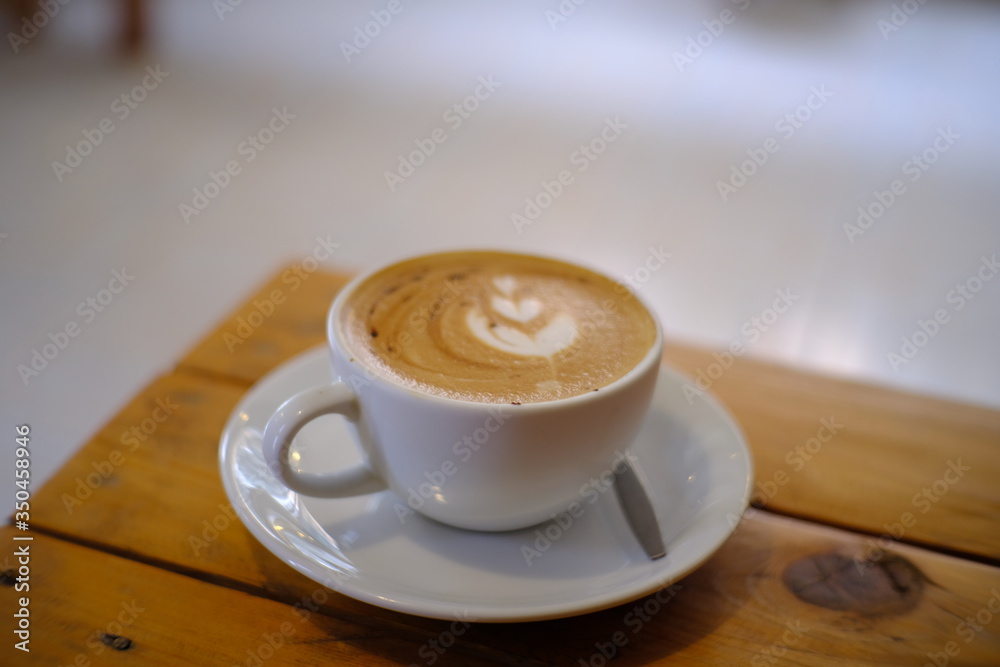 Fototapeta hot latte coffee put on table