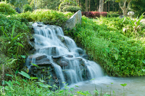 Closeup of small waterfall in the garden decorated