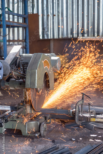 Worker Cutting of Steel in workshop