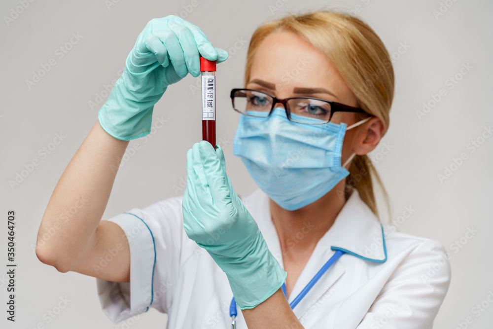 medical doctor nurse woman wearing protective mask and gloves - holding virus blood test tube medical doctor nurse woman wearing protective mask and gloves - holding virus blood test tube