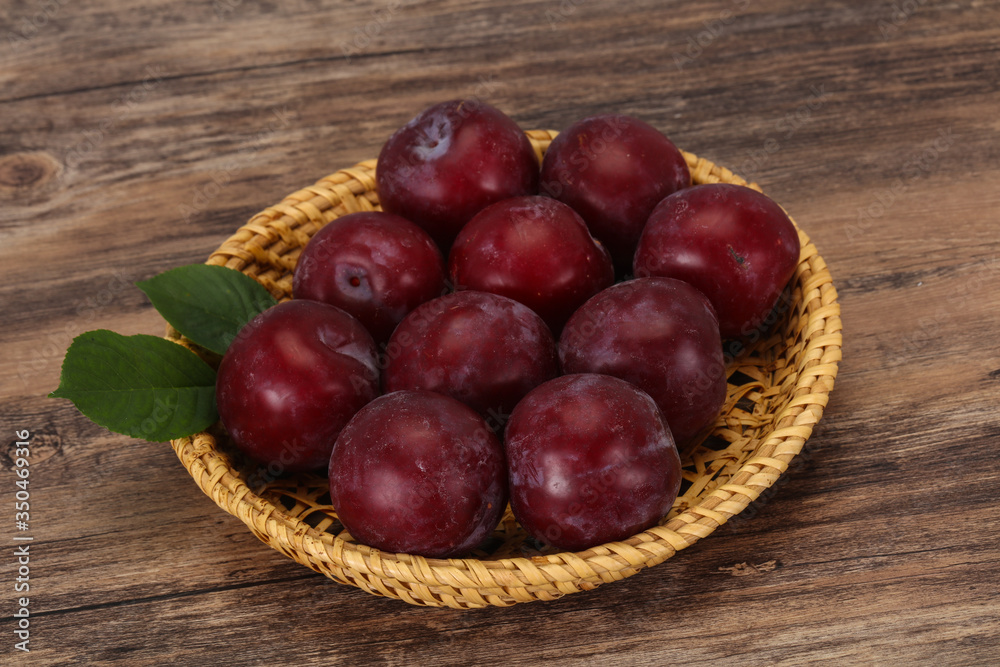Plum heap in the wooden basket