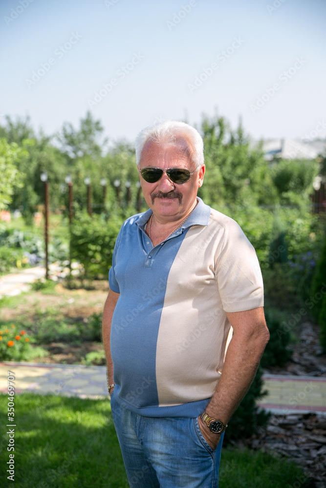 Senior grey-haired man in sunglasses in summer Senior grey-haired man in sunglasses in summer