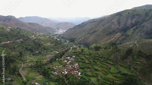 Road that crosses a beautiful  valley in the middle of the andes mountain with farms in Peru called EL VALLE DEL MANTARO. photo