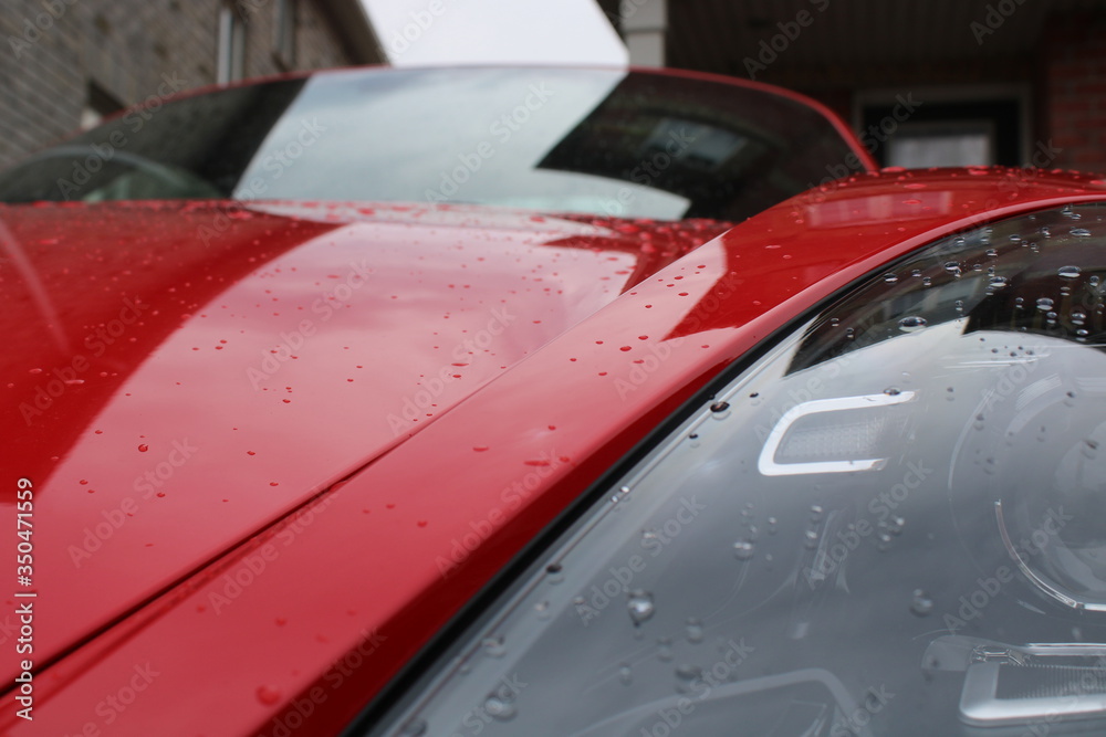 RED CAR IN THE RAIN