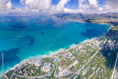 Panorama of the resort village of Kabardinka is located on the shore of Tsemesskaya Bay at the foot of the Caucasus mountains. In the background the city of Novorossiysk 