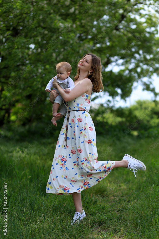 mom with a child have fun playing in a flower field and grass in the sun in a park mom with a child have fun playing in a flower field and grass in the sun in a park