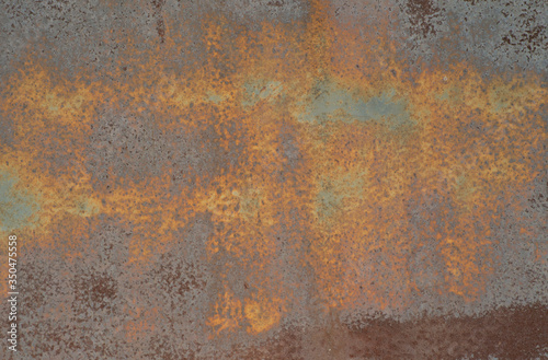 the rusted surface of painted metal garage door
