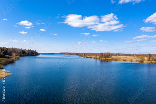Wide Uvodsky reservoir with blue water of the reflected sky, Russia.