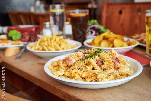 Käsespätzle Kasspatzn Knöpfle mit Röstzweibeln und Käse überbacken im Restaurant Biergarten Wirtshaus photo