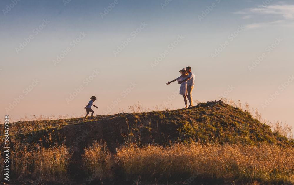 Couple waiting their son on a hill