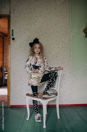 Portrait of girl holding toy bird at home