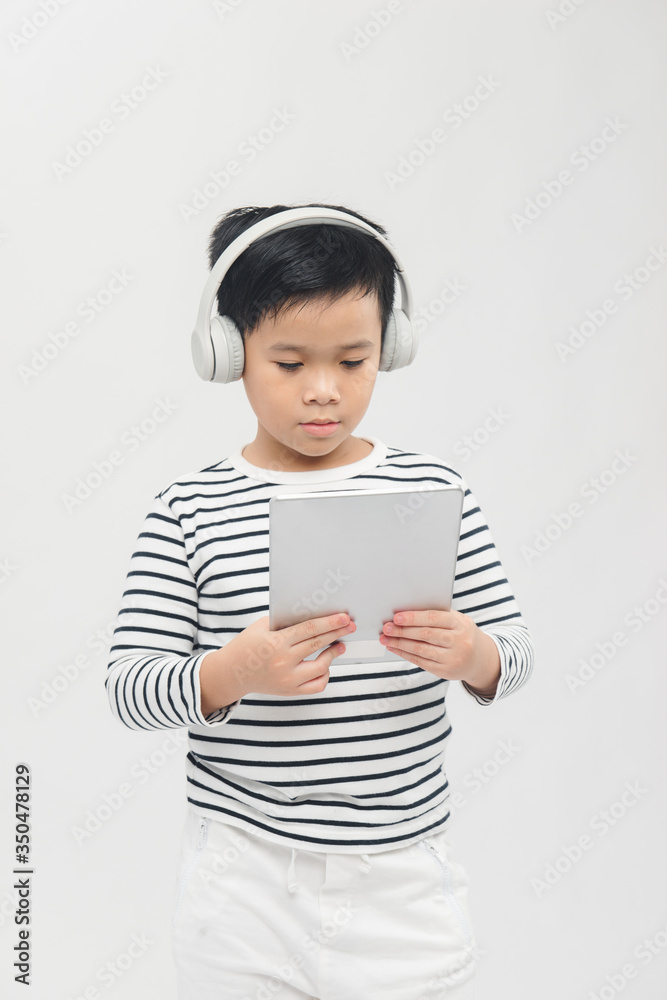 Little boy is concentrated gaming with digital tablet Little boy is concentrated gaming with digital tablet