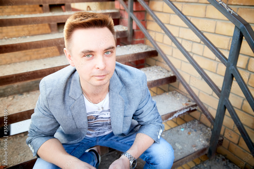 Kirov, Russia - September 04, 2019: Portrait of a handsome fun man outdoors in the city Kirov, Russia - September 04, 2019: Portrait of a handsome fun man outdoors in the city