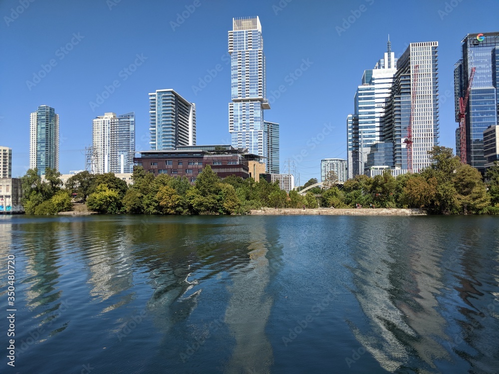 skyscrapers in the Austin with river reflections with clear blue skies skyscrapers in the Austin with river reflections with clear blue skies