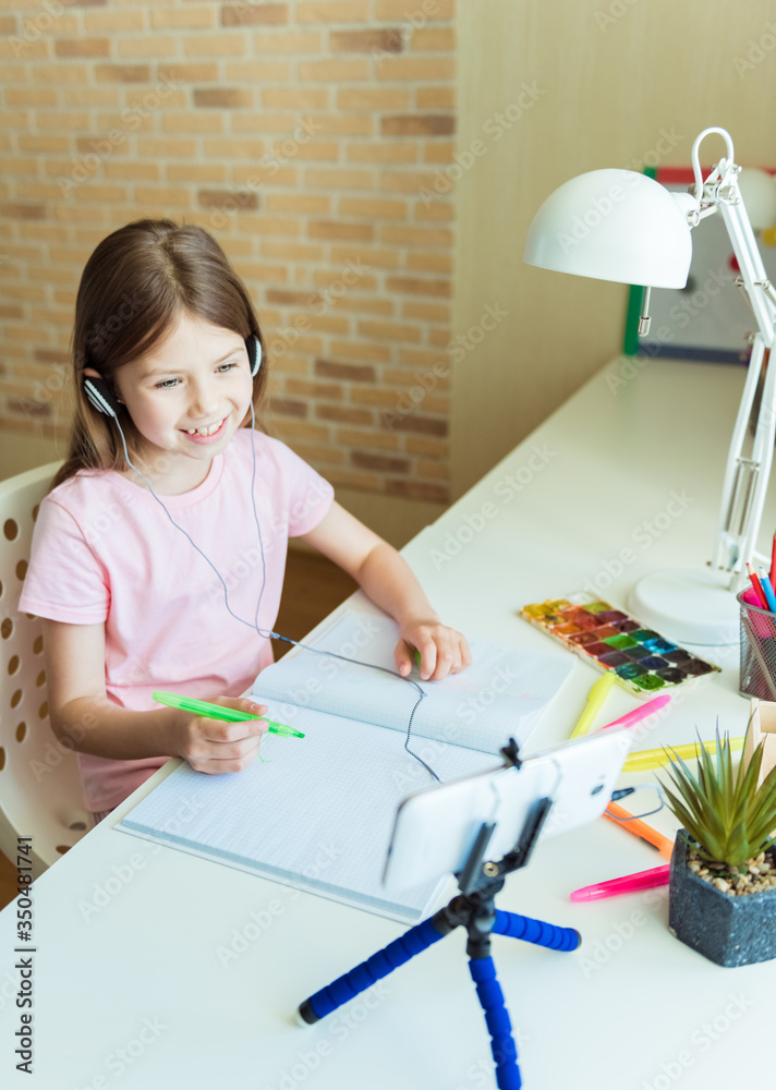 Beautiful creative girl is creativity and the artist in an online drawing paints lesson. Childrens creativity. The concept of distance learning online school for the period of global quarantine Beautiful creative girl is creativity and the artist in an online drawing paints lesson. Childrens creativity. The concept of distance learning online school for the period of global quarantine