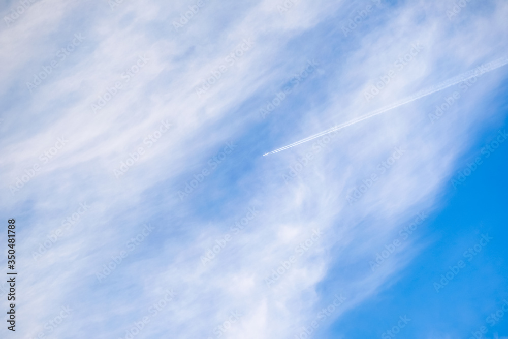 Beautiful blue sky and white clouds in summer season with transportation airplane movement high speed jet air traffic track on background. Beautiful blue sky and white clouds in summer season with transportation airplane movement high speed jet air traffic track on background.