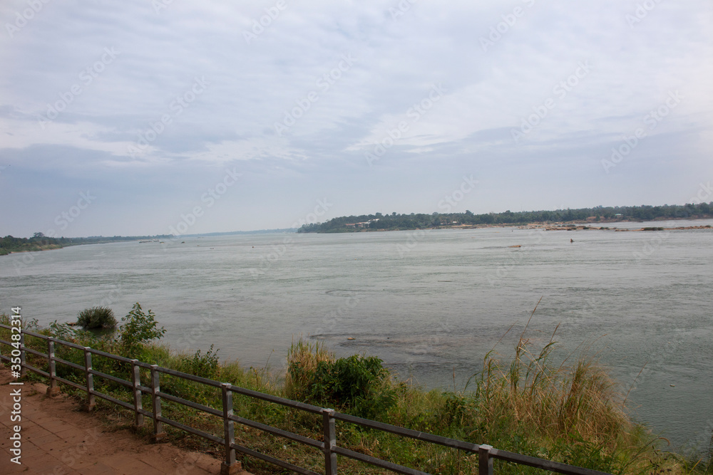 View landscape grand canyon biggest rock reef and movement water of Maekhong or mekong river while raining strom at Kaeng kabao of KaengKabao city in Mukdahan, Thailand