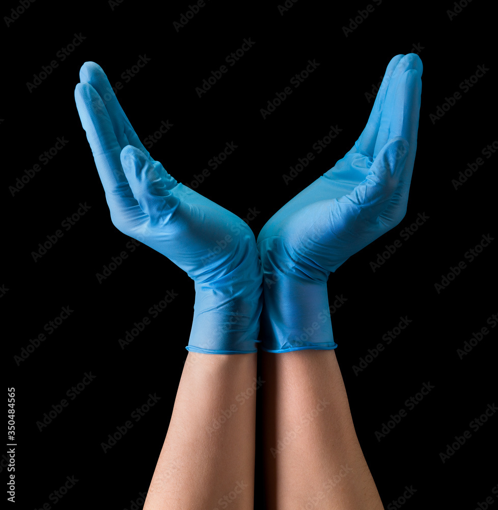 Doctor's hand in sterile medical gloves hold earth shape isolated on black Doctor's hand in sterile medical gloves hold earth shape isolated on black
